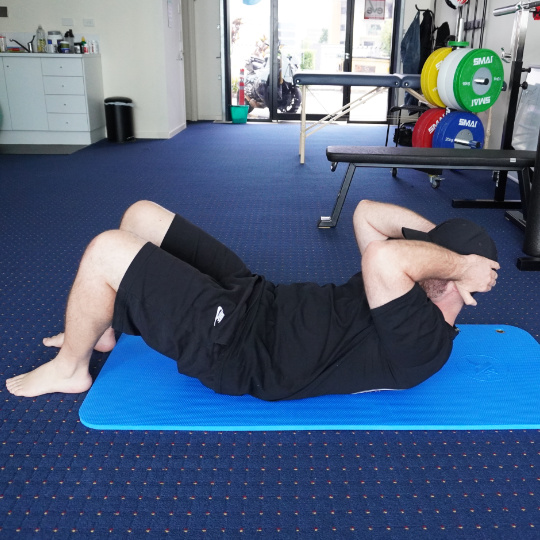 Crunch540 - Brisbane Back Pain Program | McGill Certified Practitioner | Online Coaching Photo of a stomach crunch exercise